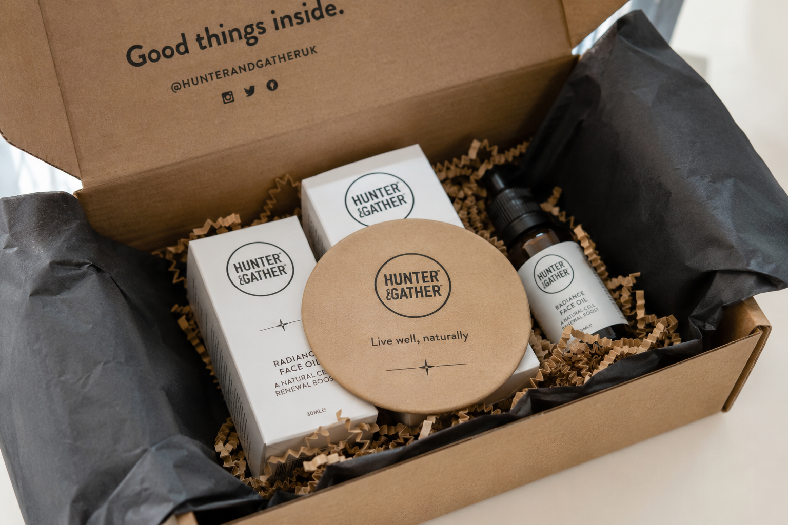 Branded custom coaster placed inside an e-commerce packaging box with premium product items